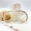Clear crystal with natural elements on a white background