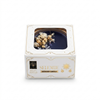 Selenite scented candle in packaging with floral elements on a white background